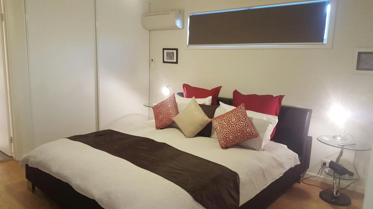 King size bed, with reverse cyle heating and cooling and wall mounted TV.