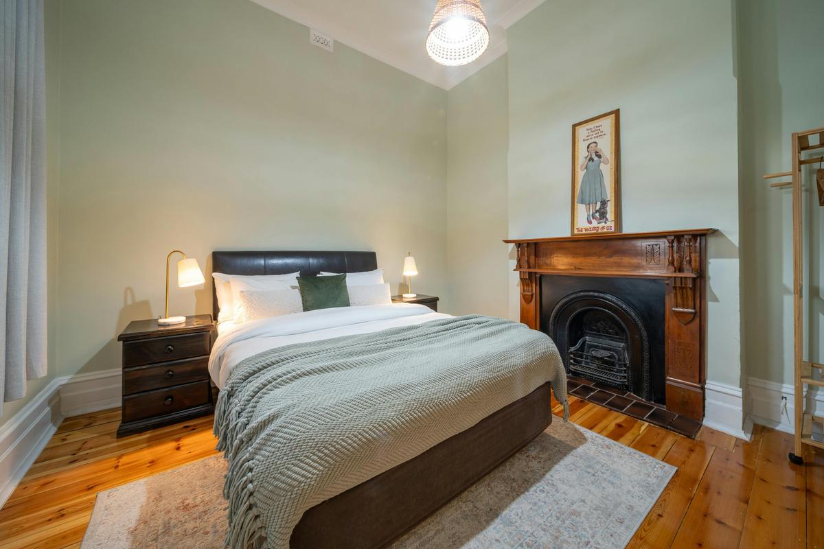 Bedroom 2 - Queen size bed comfort with plush bedding, Ducted AC and soft warm tones.