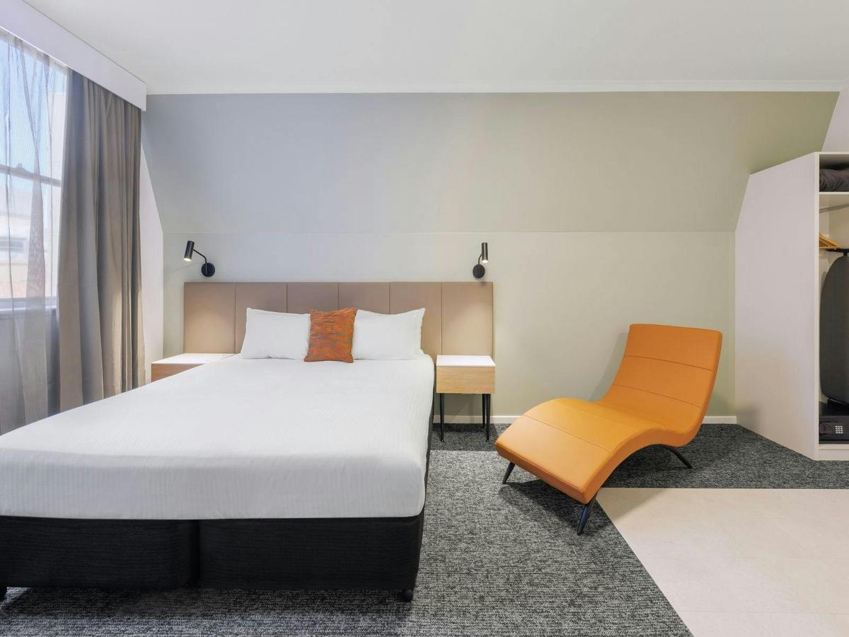 Luxury Spa Room with a deep spa bath, plush king bed, and modern décor for a relaxing stay.
