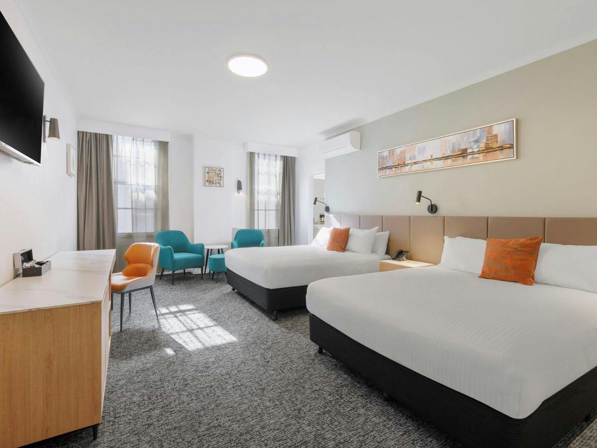 Twin Room with two beds, modern décor, warm lighting, and stylish furnishings