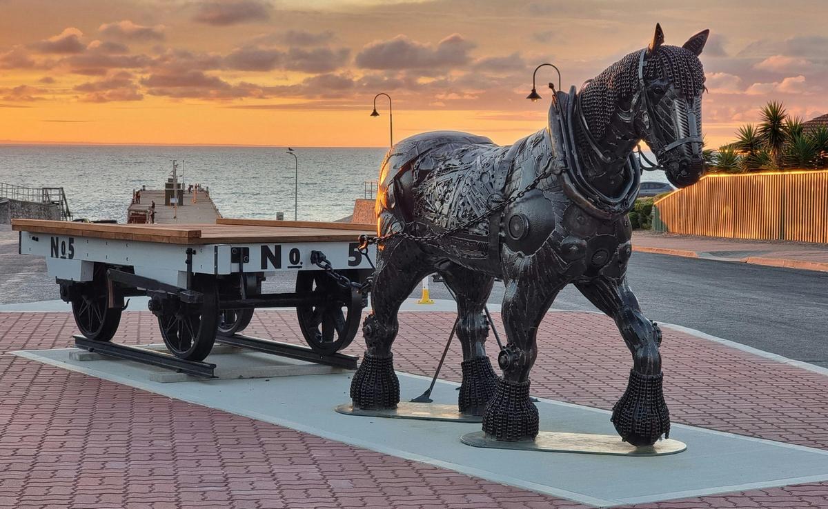 The sun rises over Edithburgh jetty shining a golden glow over 'Edith'