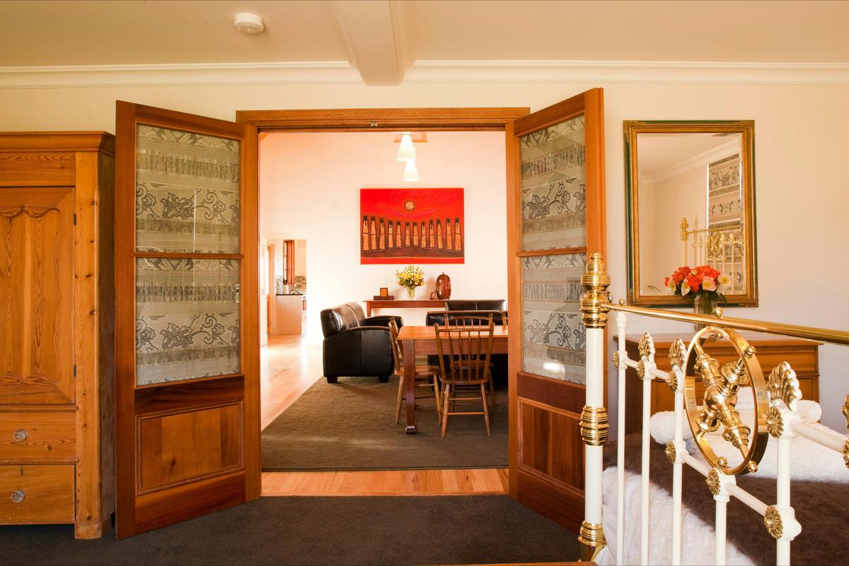 View into living area through French doors in downstairs bedroom.