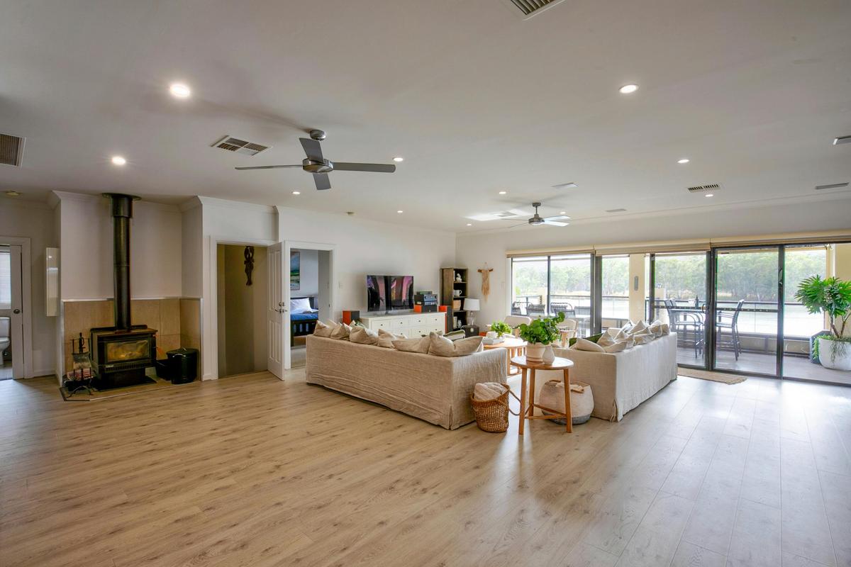 stunning open plan living, large lounge with combustion heater and stunning views