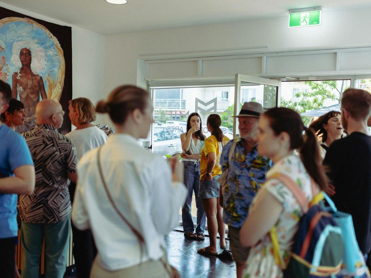 A group of people connect in The Mill's foyer