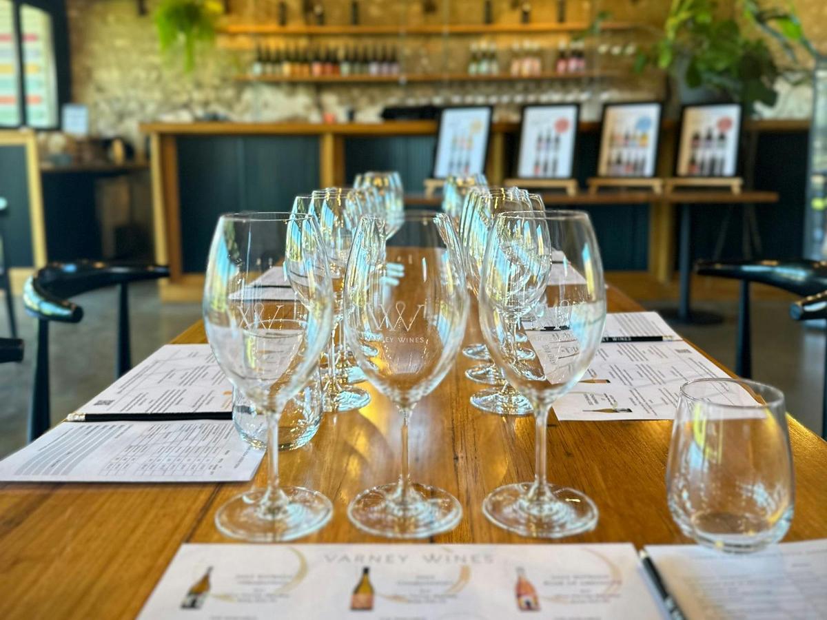 Varney Wines branded glasses on a set table ready for the structured tasting at Varney Wines