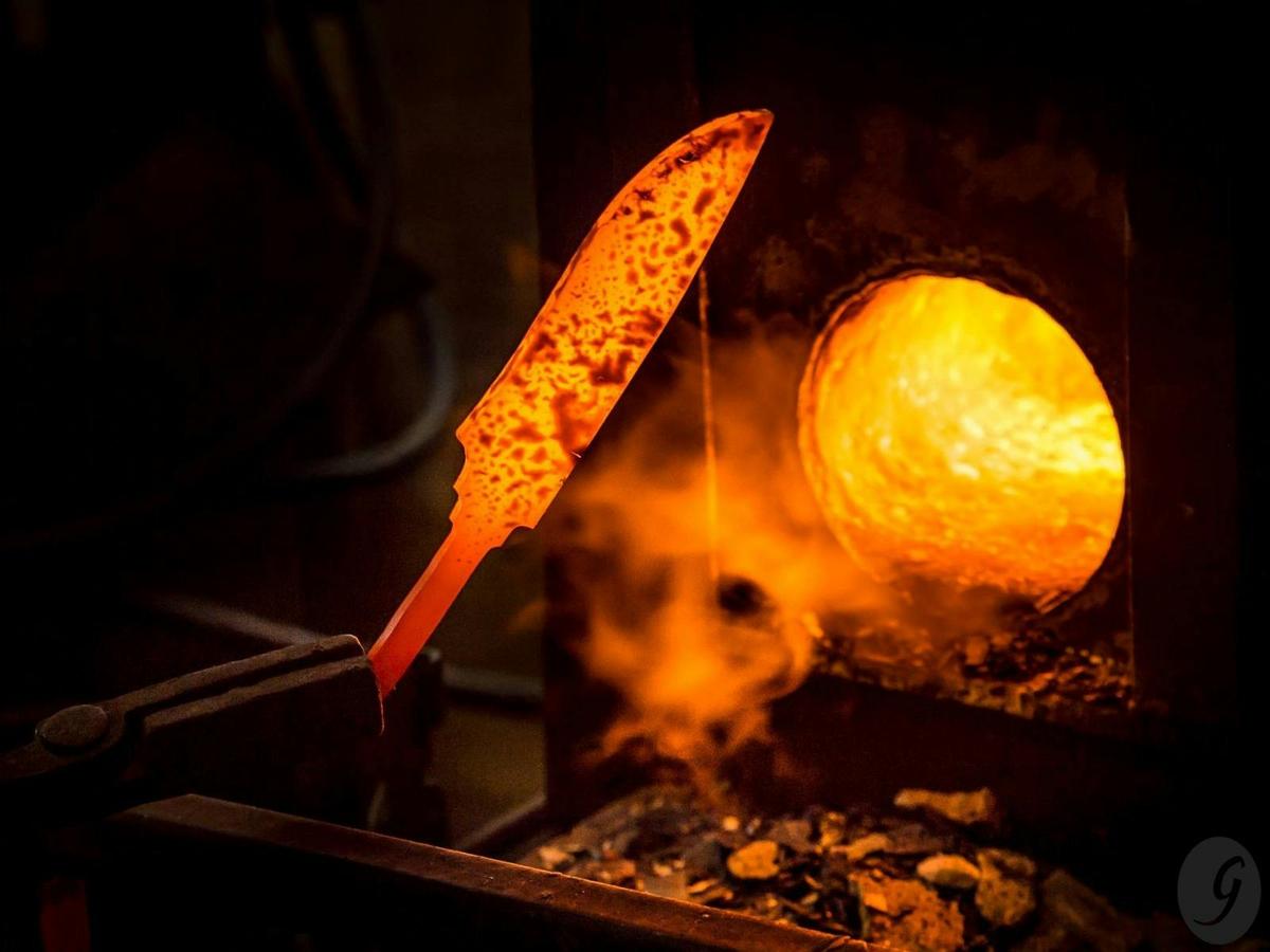 Hand-forged knife being checked.
