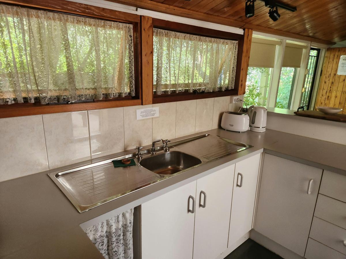 Small kitchenette with cooking facilities, including kettle, toaster, microwave and hotplates.
