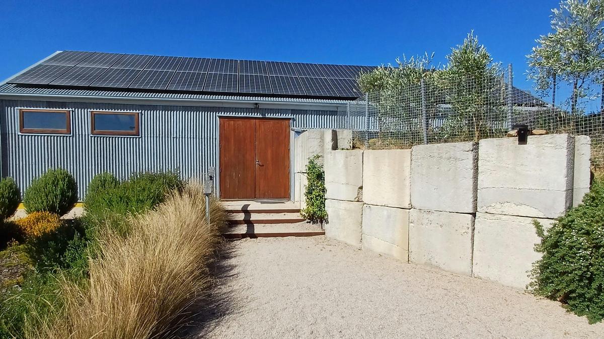 Zero net carbon cellar door front. We export three times the amount of electricity we use. We designed the building to be energy efficient.