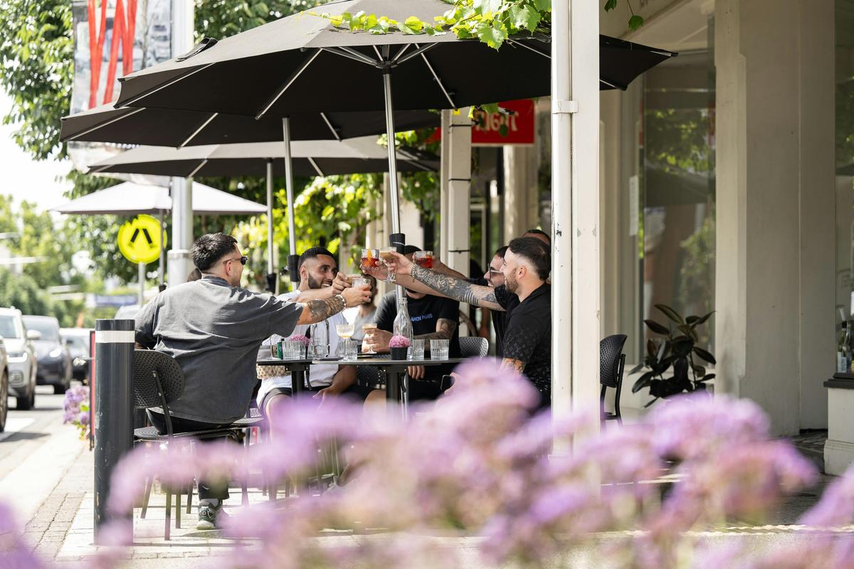 Guys cheers at bar