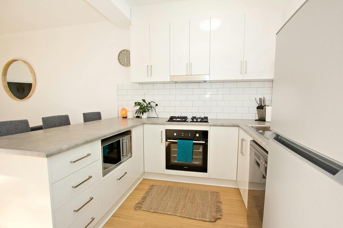 Kitchen with cook top, oven, microwave, dishwasher, fridge