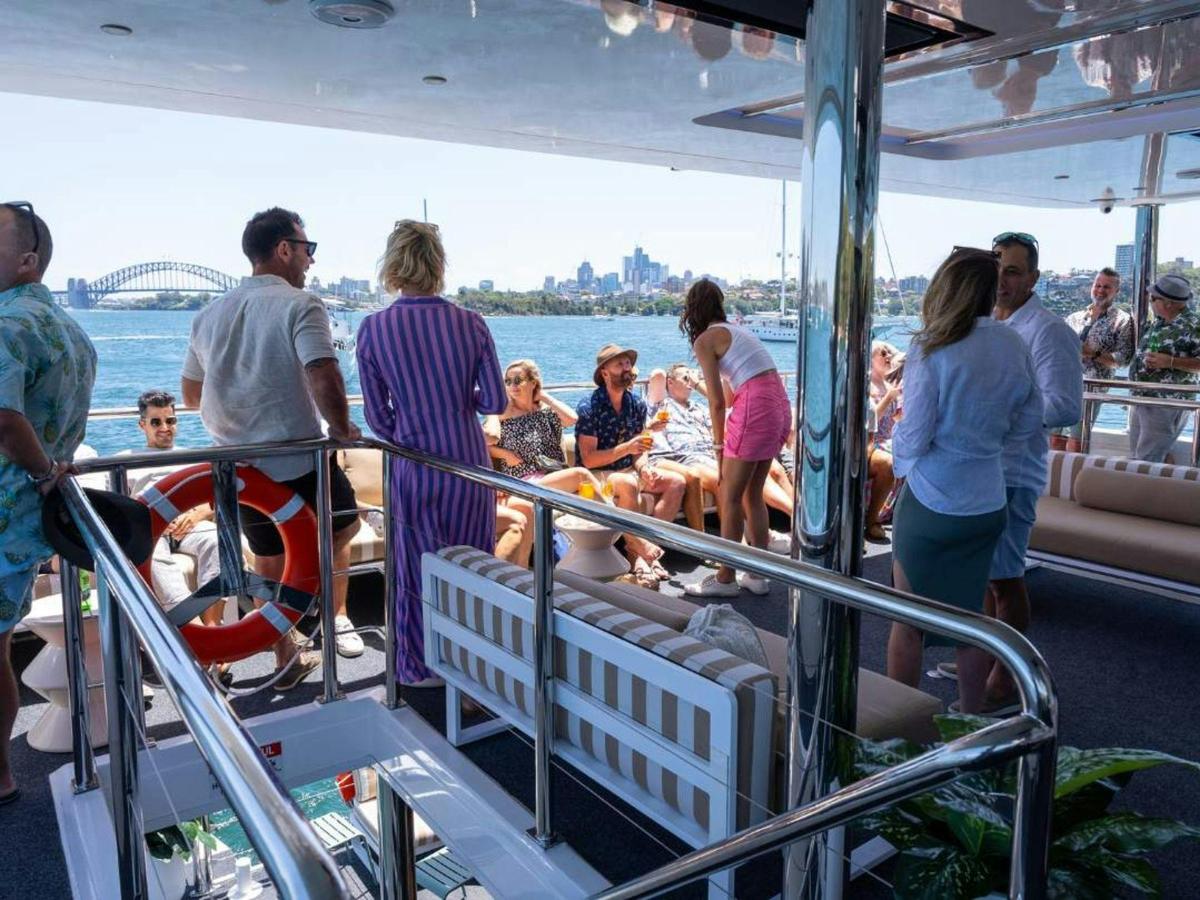 Guests enjoying the open deck aboard Karisma 2 on Sydney Harbour