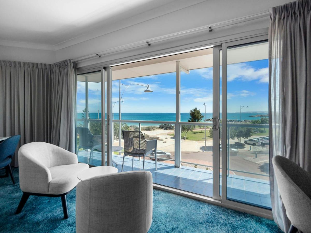 View from our Fourth Floor Suite, featuring a comfortable indoor seating area, private balcony and v
