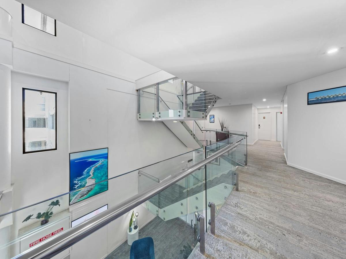Third-floor landing at Ocean Centre Hotel, featuring the open atrium design and internal staircase c