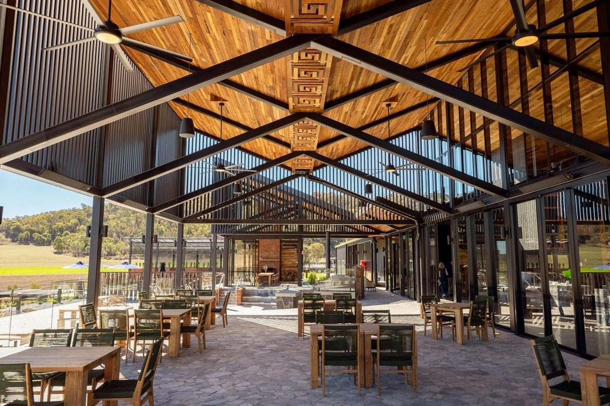 The Terrace is set beneath soaring timber-lined gables and framed by handcrafted stonework.