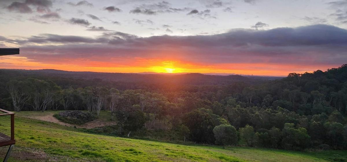 A spectacular sunset over the surrounding bushland, viewed from Rock Hill Hideaway.