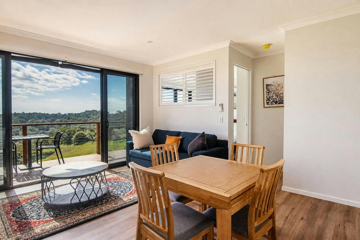 The open-plan dining and living area offers a comfortable place to relax while enjoying the view.