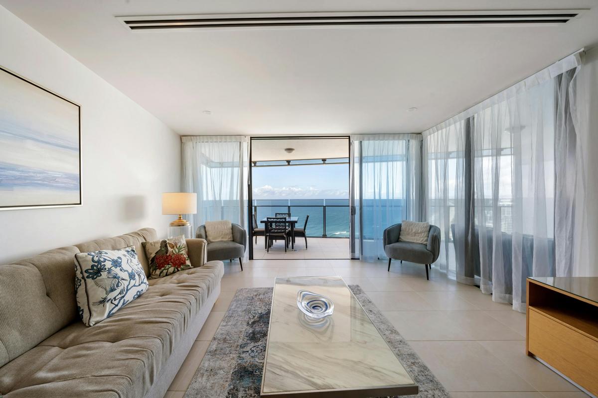The living room opens straight onto the balcony, with the water in front of you.