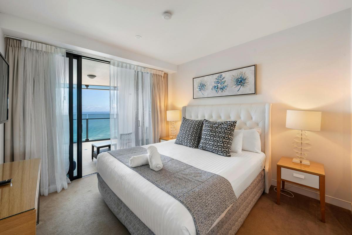The main bedroom, with its own door to the balcony and the ocean beyond.