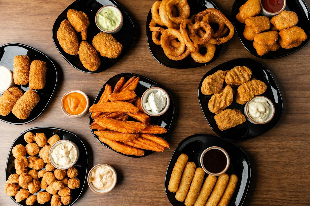 A variety of sides, from onion rings to crumbed chicken pops and a lot of dips.