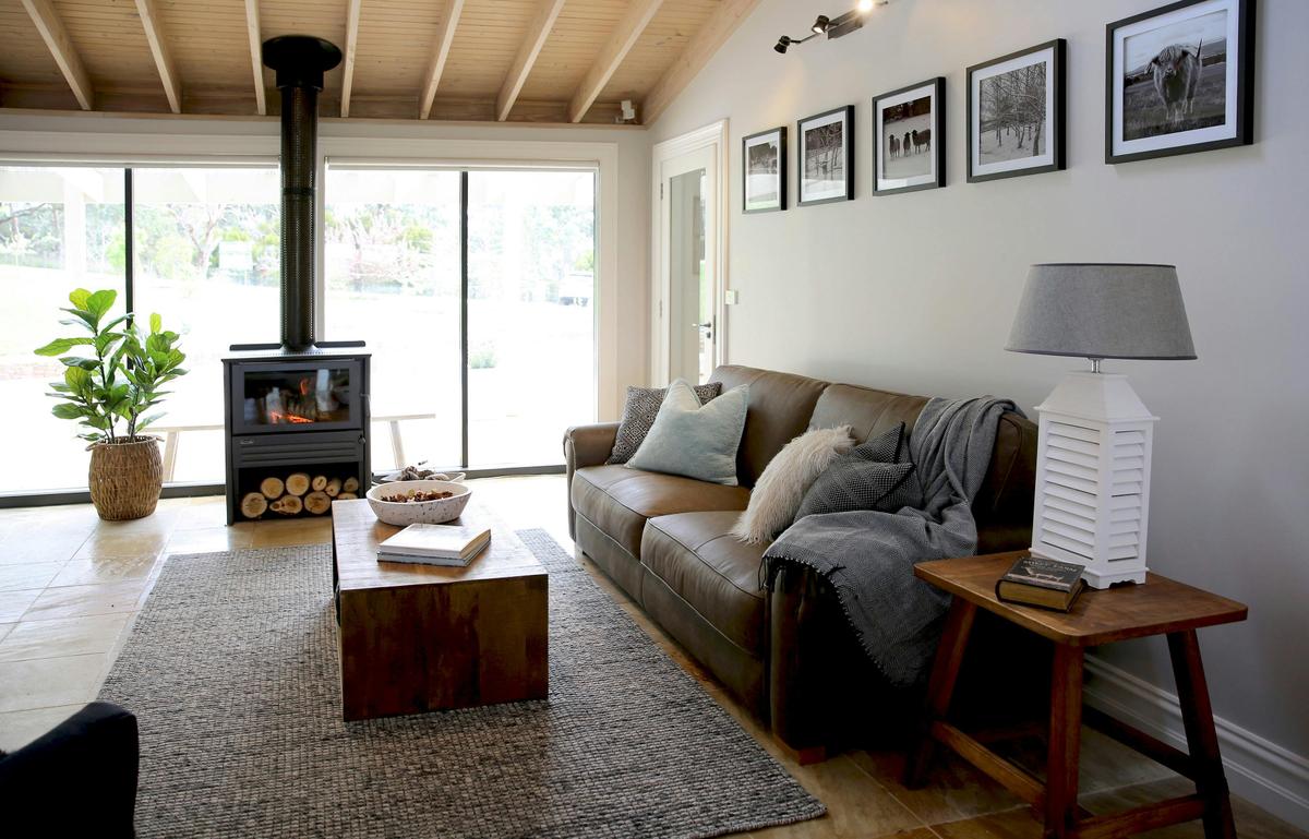 Lounge room with indoor fireplace at The Cottage