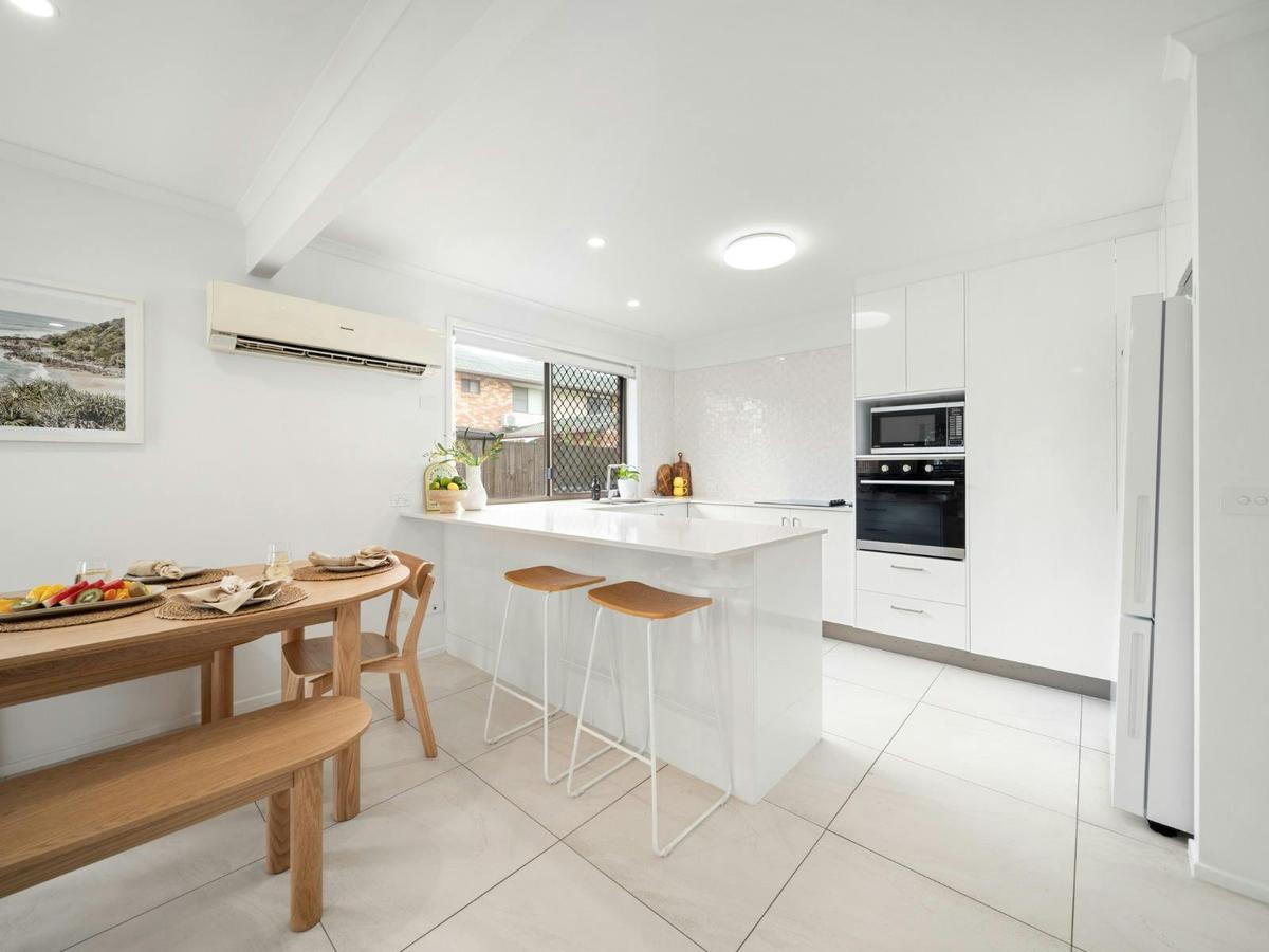 Open plan kitchen and dining area with breakfast bar