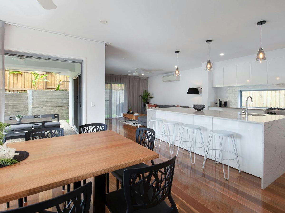 Open plan living kitchen and dining area with balcony access
