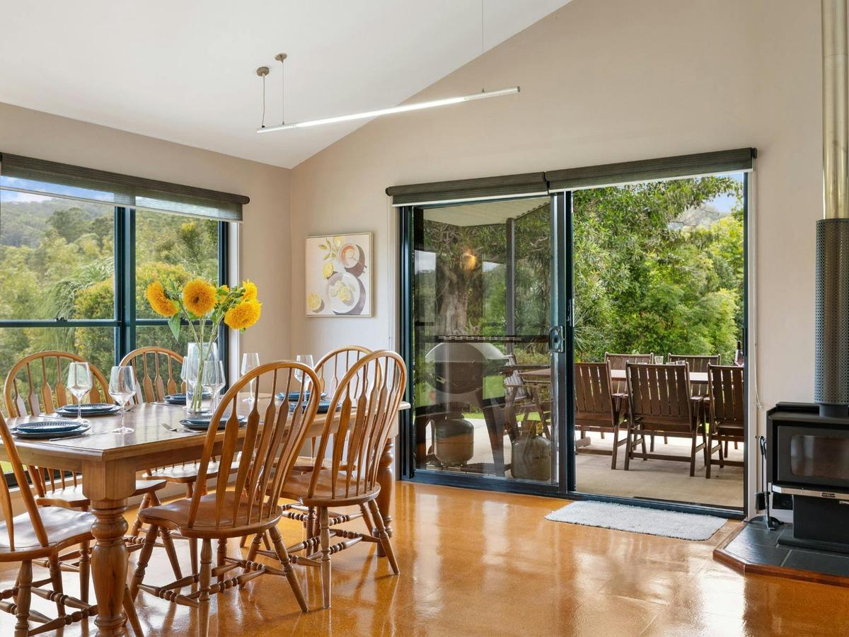 Open plan living, dining and kitchen with balcony access and indoor fireplace