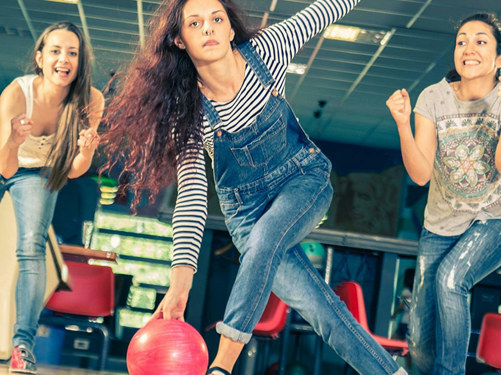 Three young women bowling