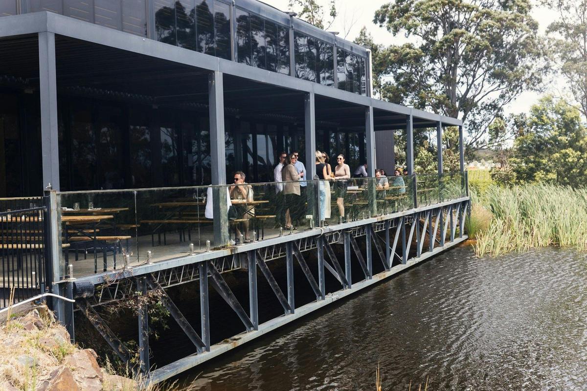 Guests dining on the deck over the lake at Il Vigneto Pizzeria, Rochford Wines