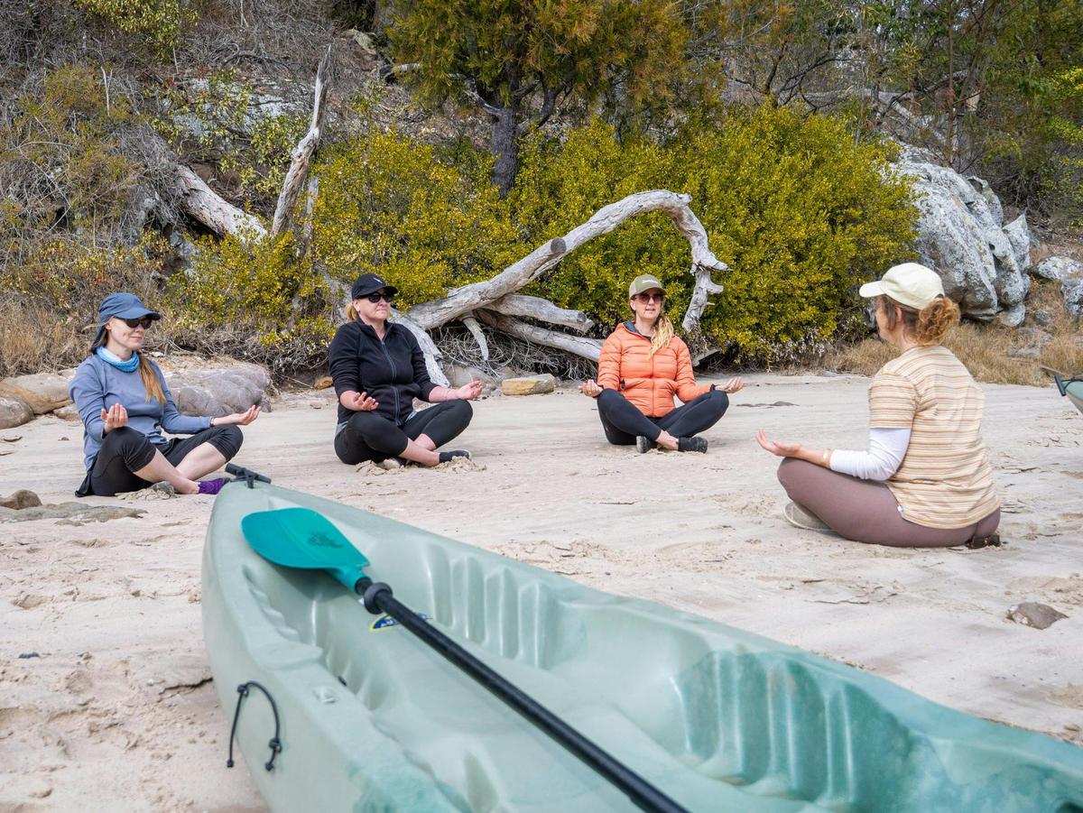 Guests guided breathing on the rivers edge