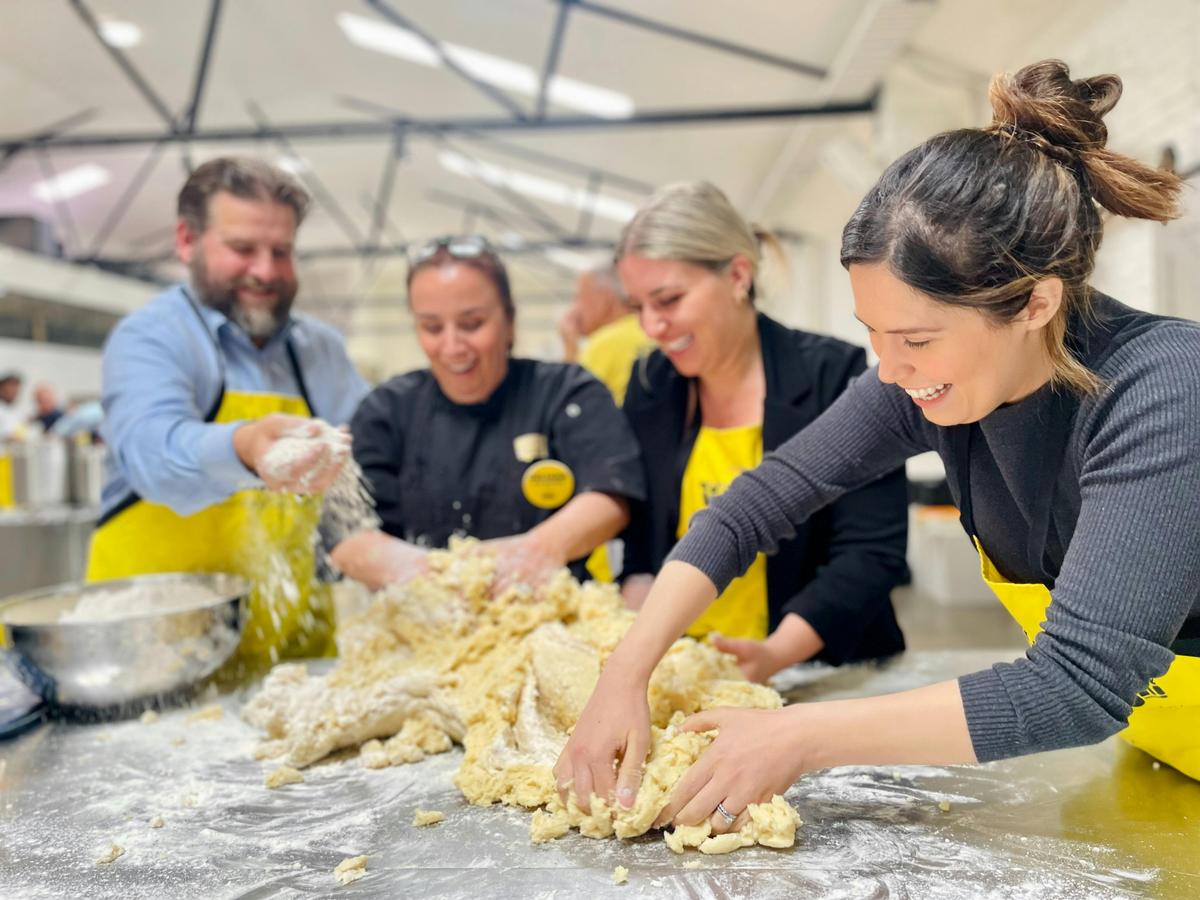Kneading dough together, flour flying.