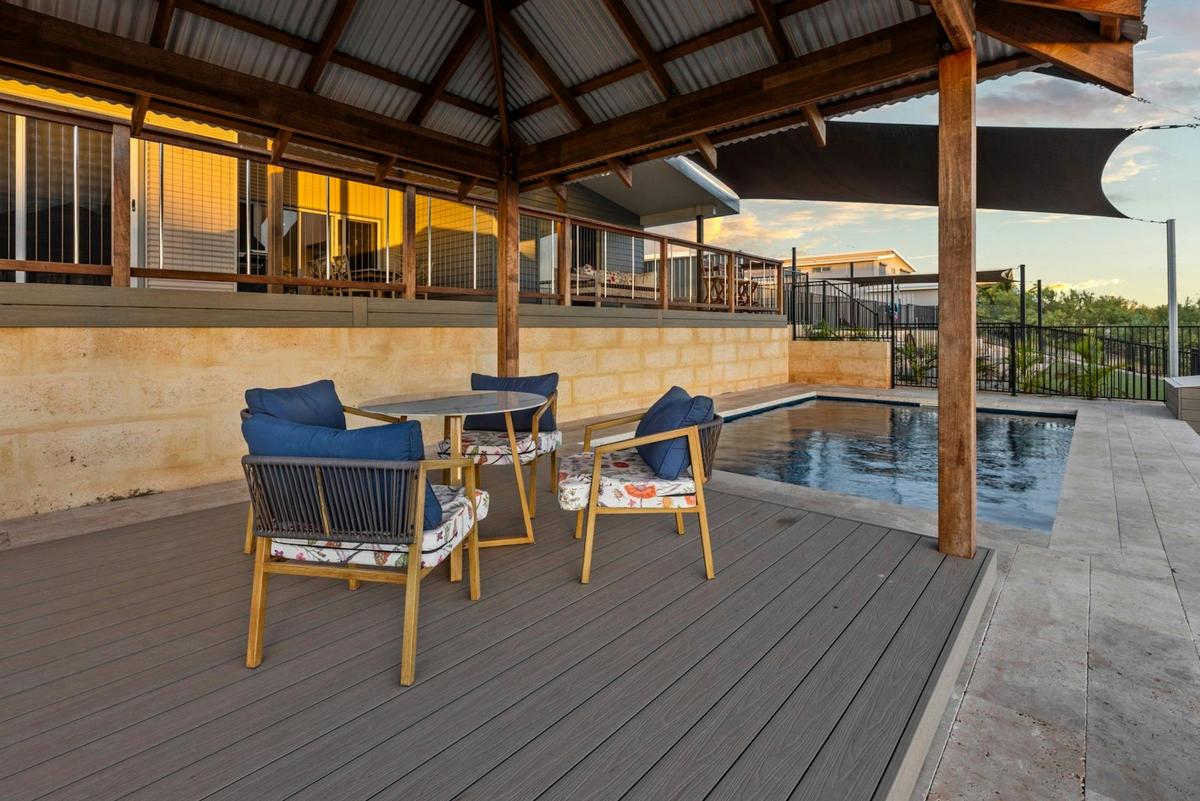 Unwind in the shaded seating area beside the pool.