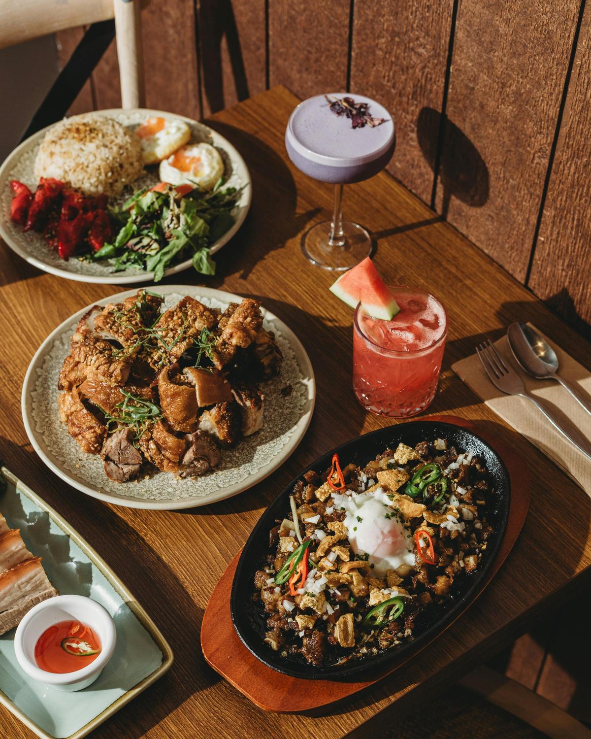A vibrant Filipino spread featuring sisig, crispy pork, silog and signature cocktails. We serve dish