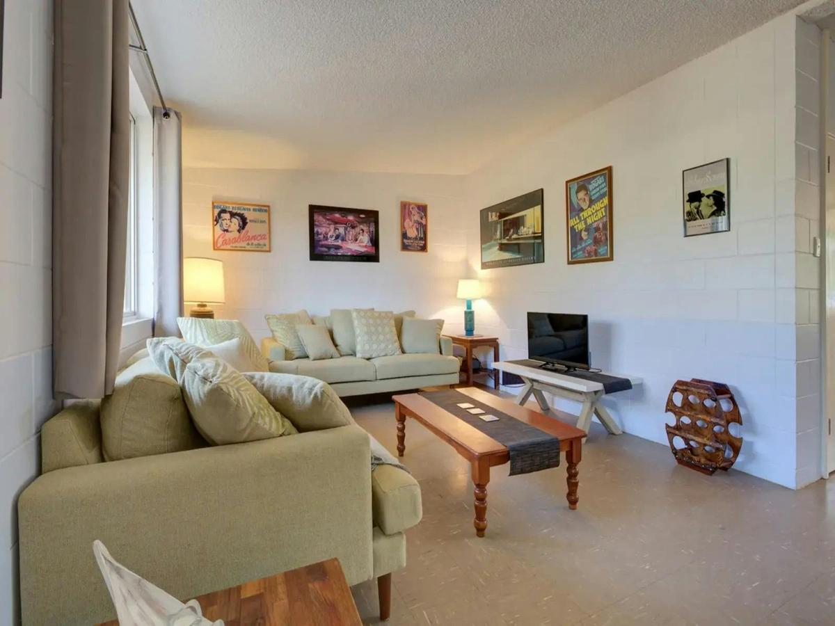 Bright living room with comfortable seating, TV, and natural light
