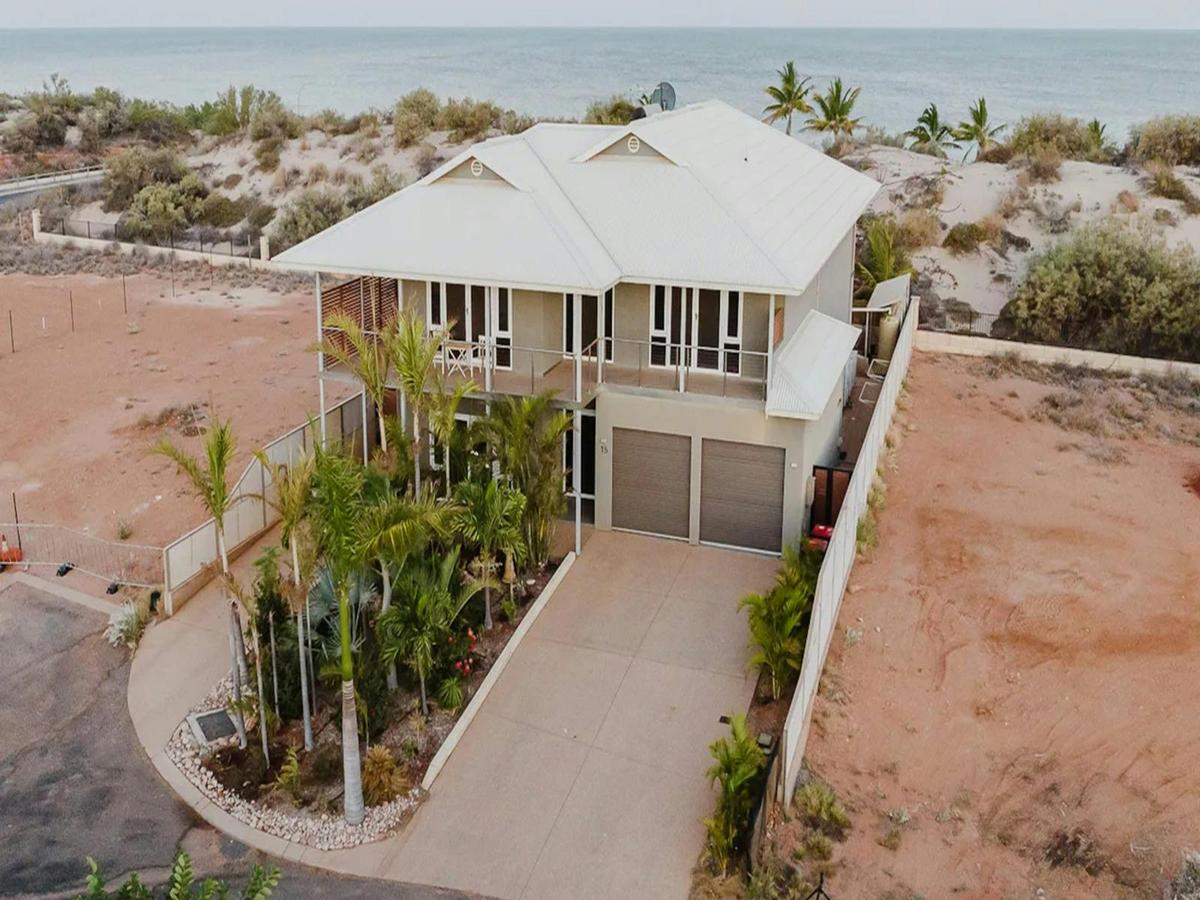 Spacious beachfront holiday home surrounded by tropical landscaping