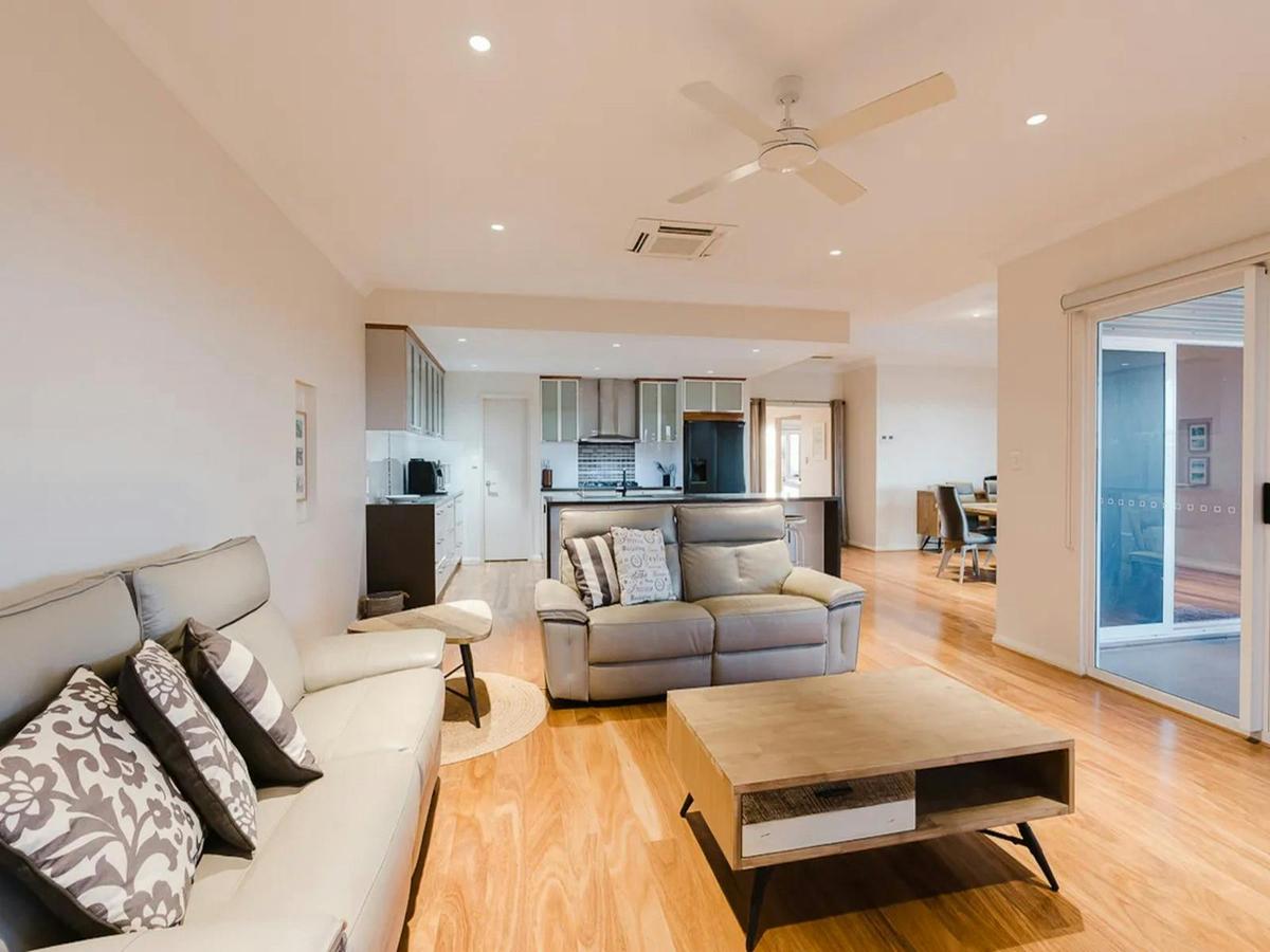 Bright open-plan living area connecting the lounge, kitchen and dining spaces