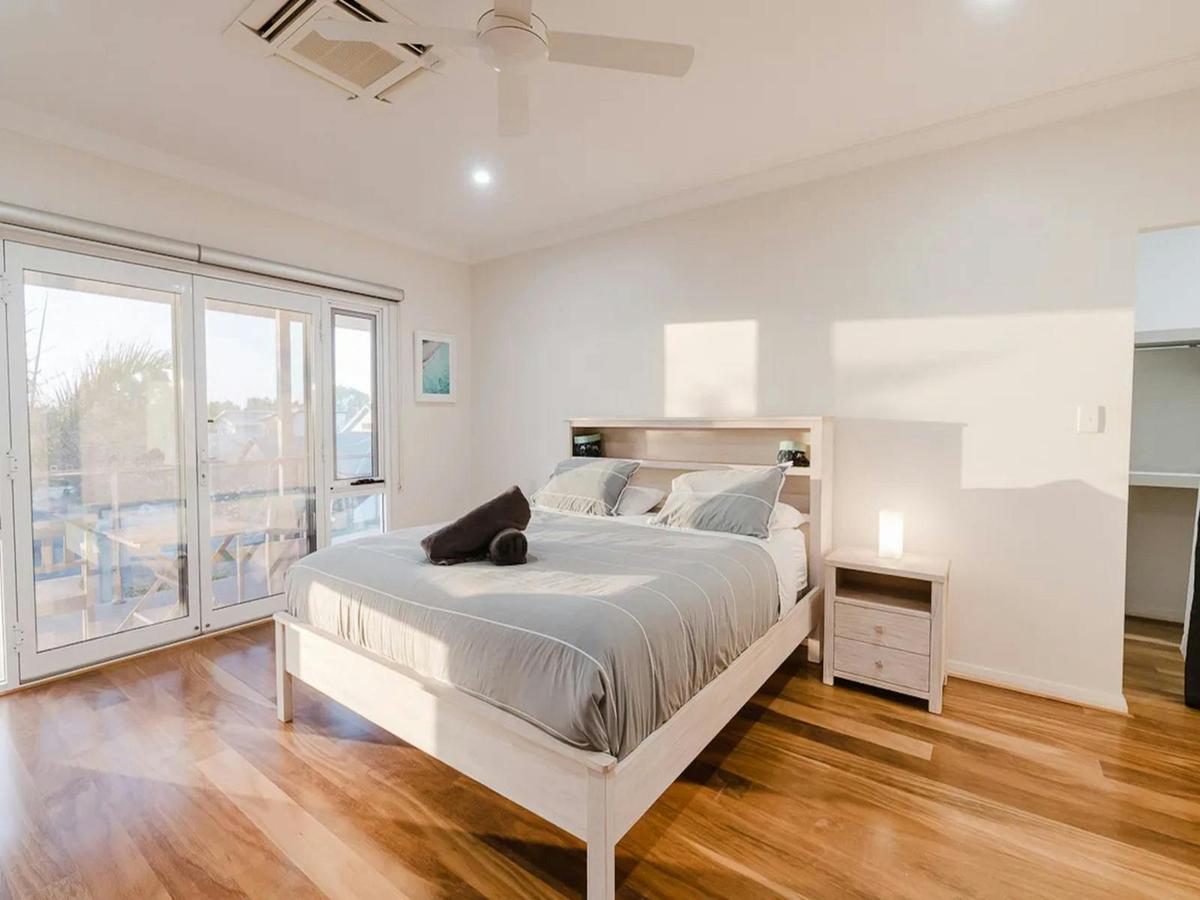 Spacious covered balcony with comfortable seating and peaceful coastal views