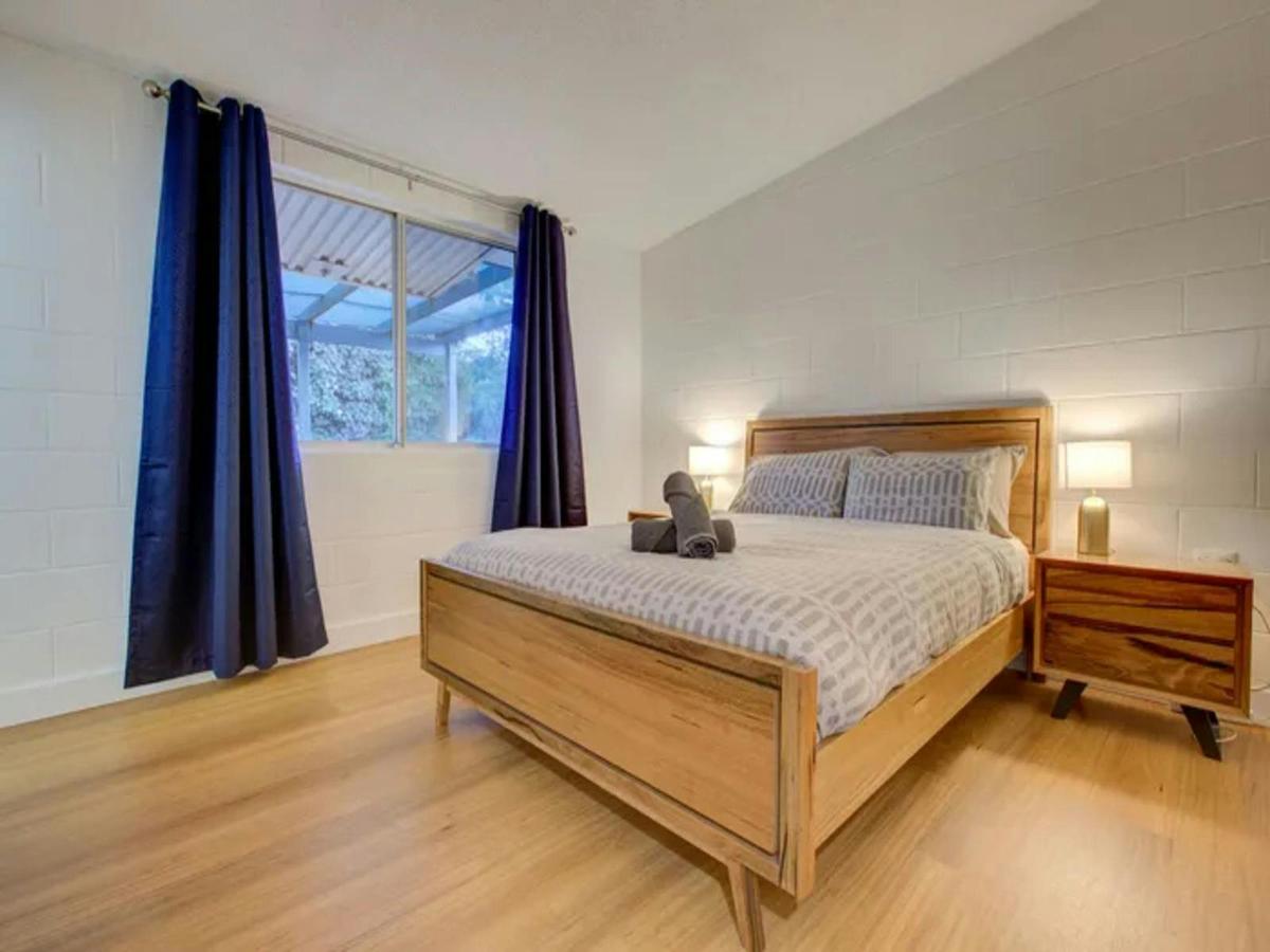 Welcoming queen bedroom with natural light and generous floor space