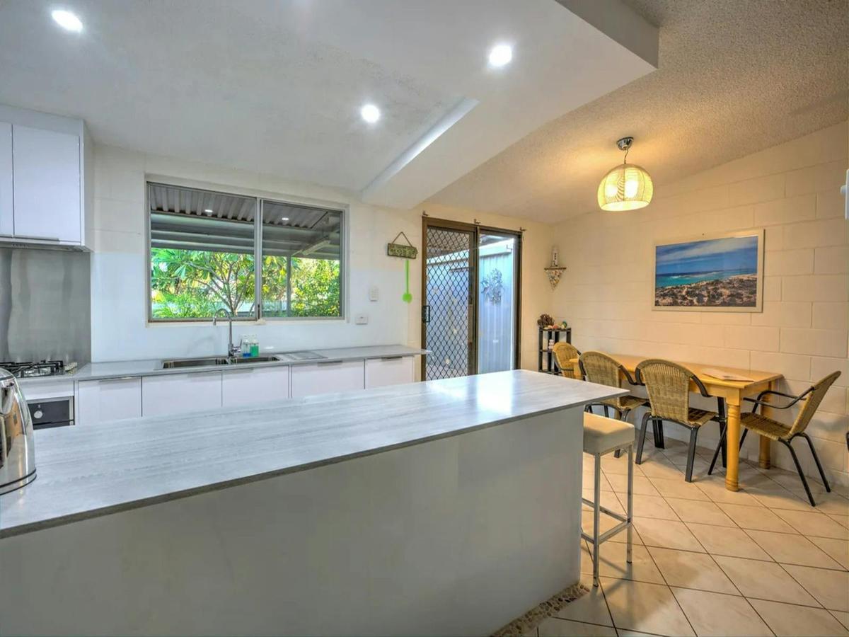 Bright kitchen with a breakfast bar and adjoining dining area