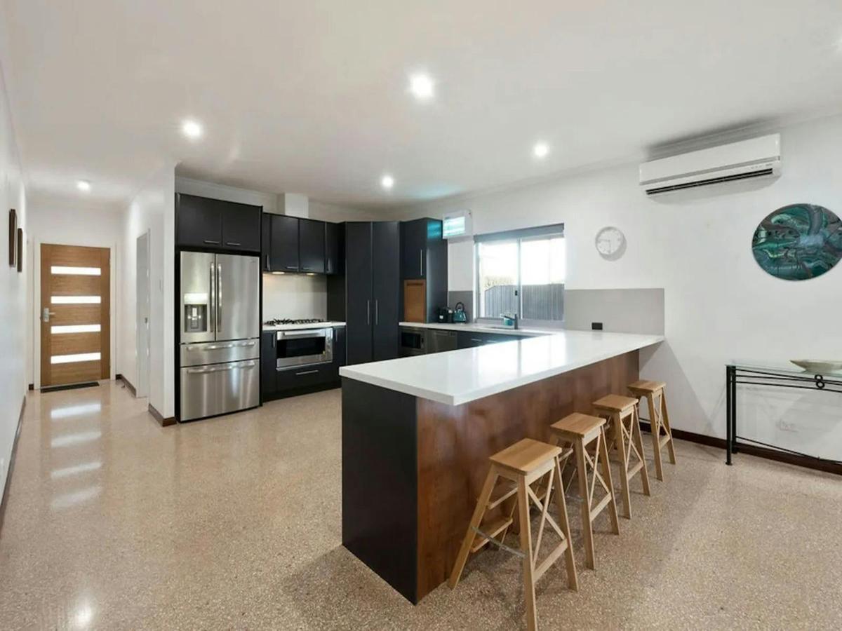 Fully equipped modern kitchen with a large island and breakfast seating