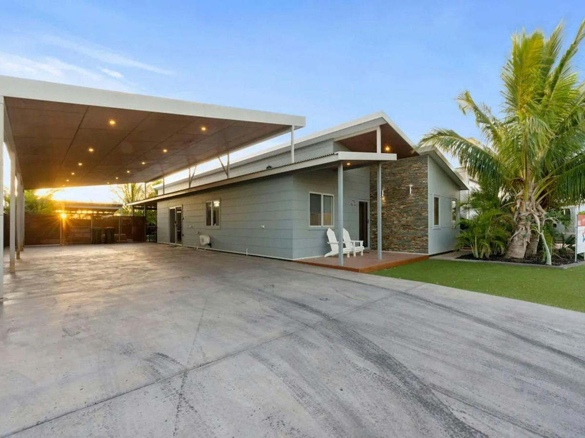 Modern holiday home with tropical landscaping and ample covered parking