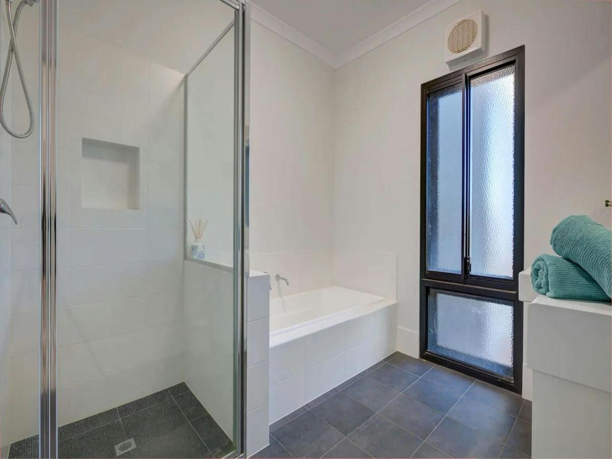 Modern bathroom with a separate shower, bathtub and natural light