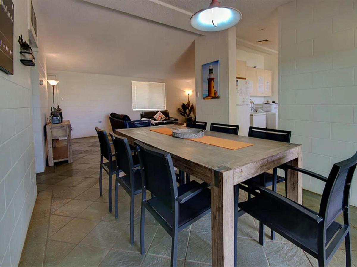Spacious dining room with seating for a group and an adjoining lounge