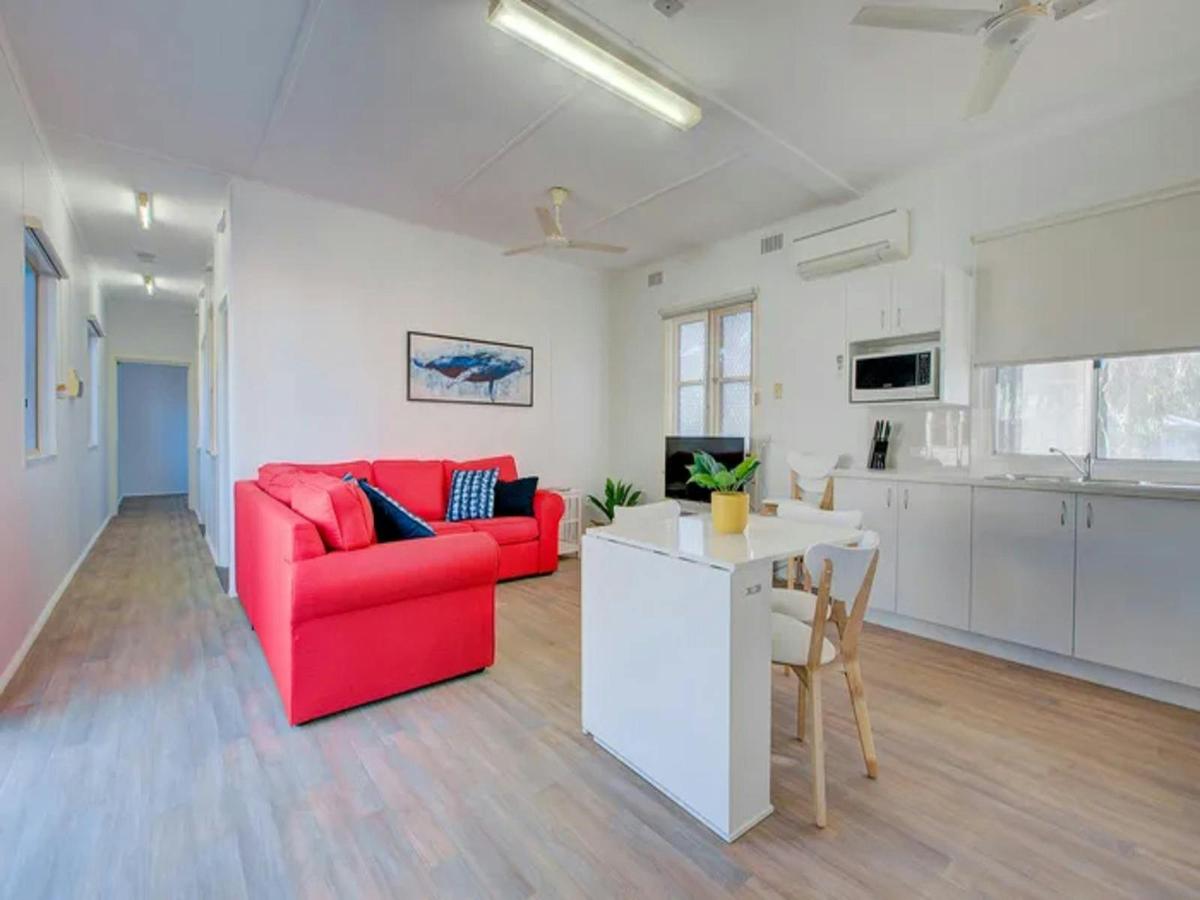 Light-filled living and dining space with a clean, modern coastal feel