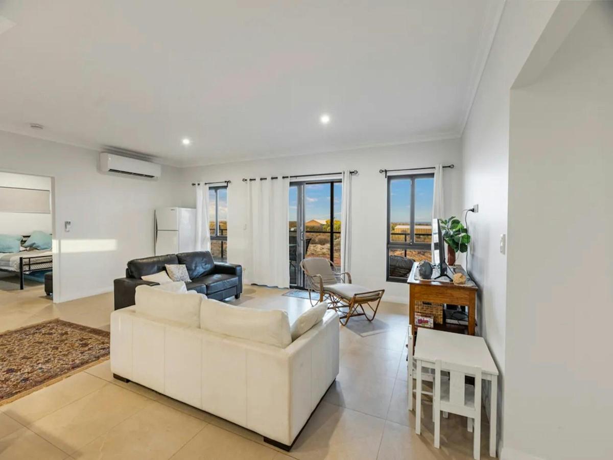Light-filled living room with comfortable seating and outdoor access