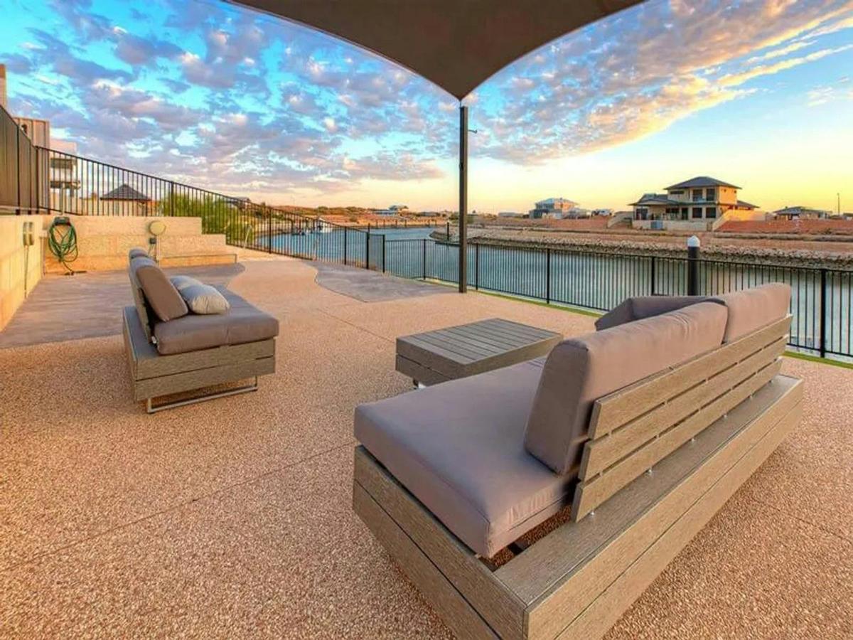 Spacious waterfront lounge area with uninterrupted marina and sunset views
