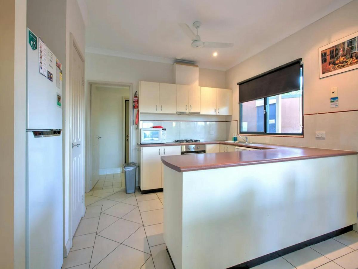 Practical open kitchen with generous counter seating and modern appliances