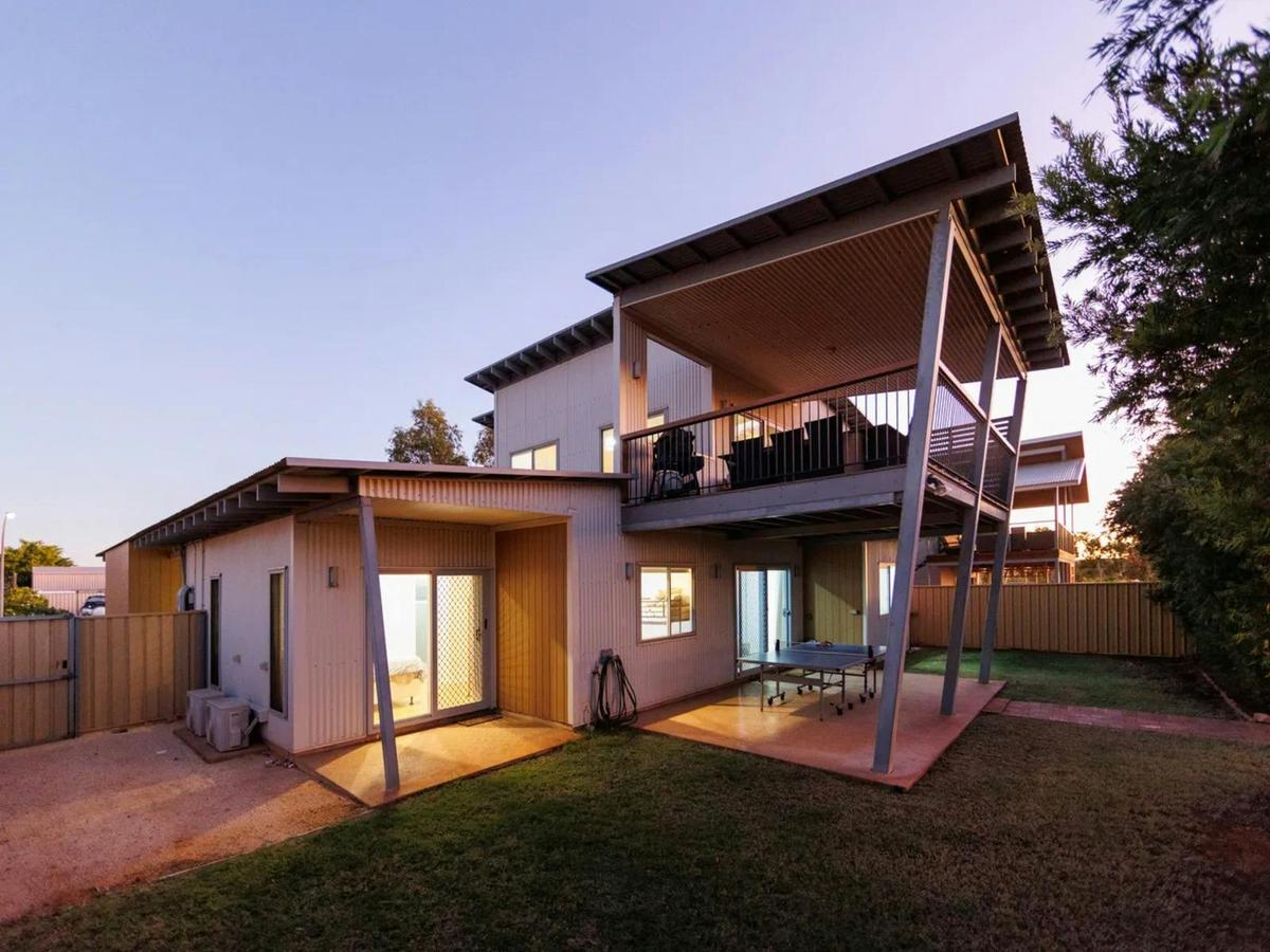 Spacious two-storey holiday home with covered outdoor areas and a fenced yard