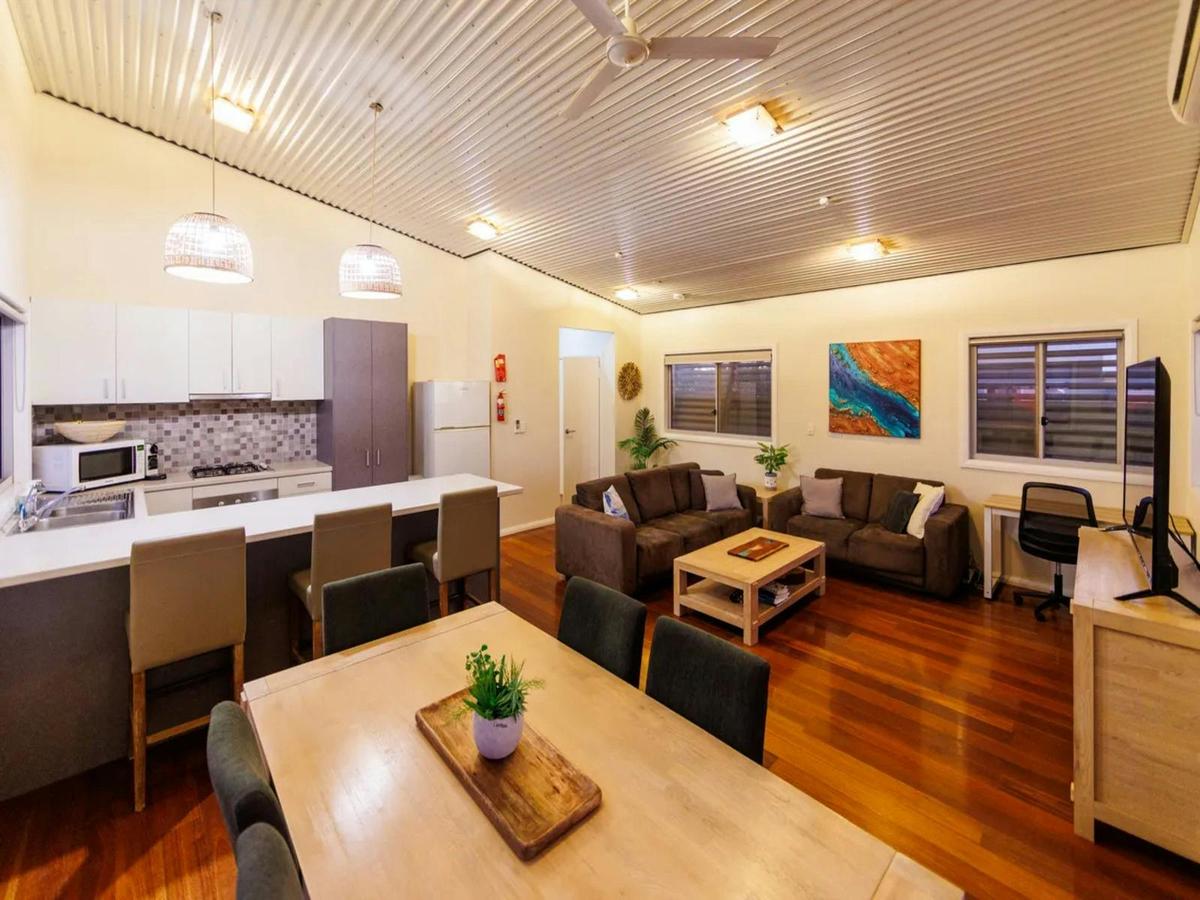 Welcoming open-plan living, dining and kitchen area with warm timber floors
