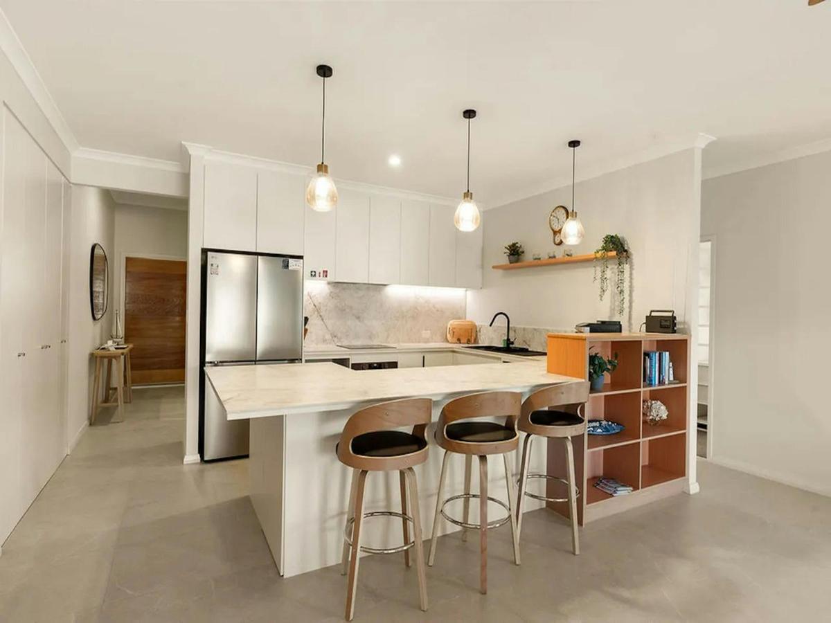 odern kitchen with a large breakfast bar and stylish pendant lighting